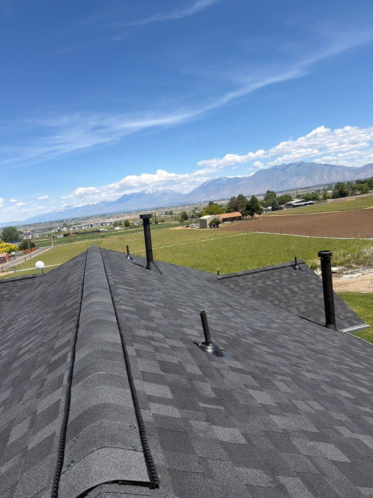 Finished black architectural roof with ridge cap along the ridge