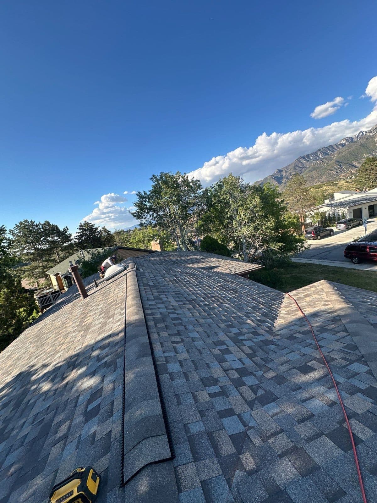 Finished grey roof with mountains behind